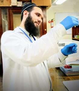 Figure 1: Abrar Hussain performing experiment in the lab.